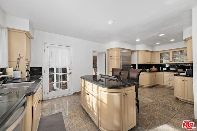 kitchen with dishwasher, a center island, backsplash, sink, and a kitchen bar