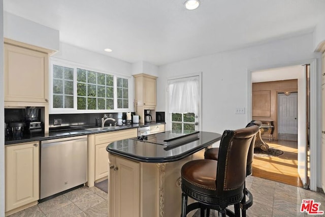 kitchen featuring dishwasher, cream cabinetry, and sink