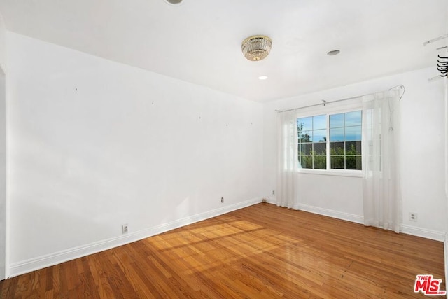 unfurnished room featuring hardwood / wood-style flooring