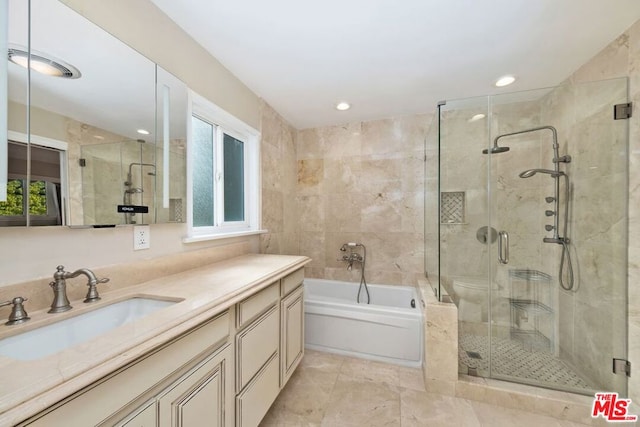 bathroom with shower with separate bathtub and vanity