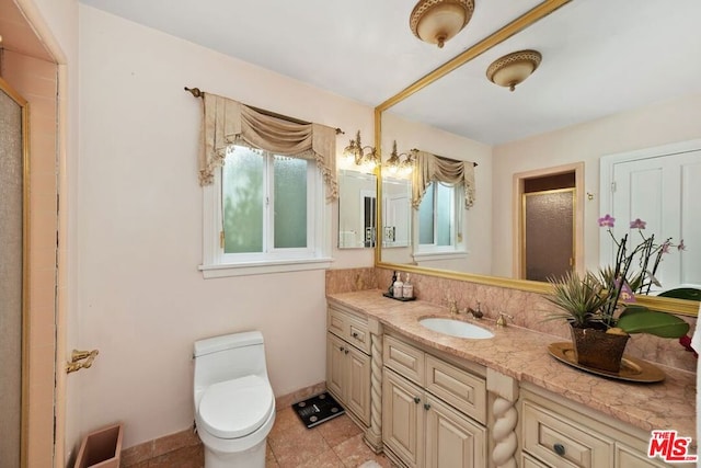 bathroom featuring toilet, vanity, tile patterned floors, and walk in shower