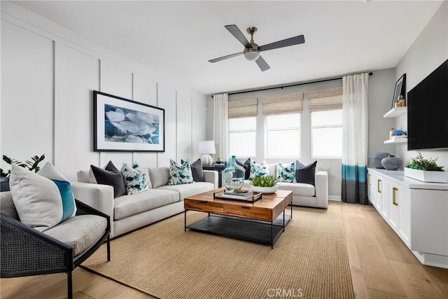 living room with ceiling fan and light hardwood / wood-style floors