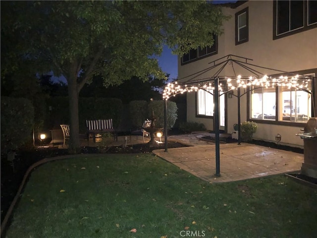 patio at night with a lawn