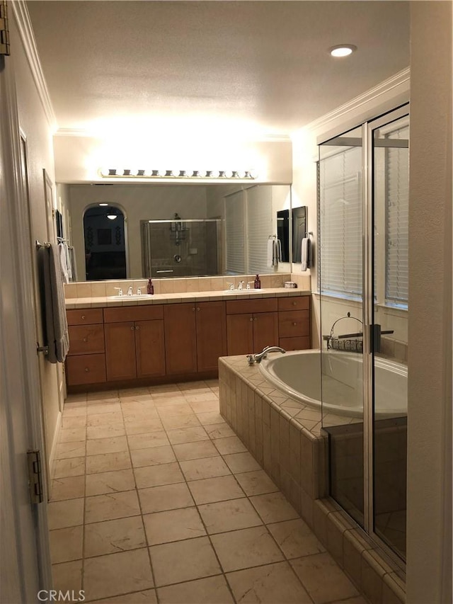 bathroom featuring tile patterned flooring, vanity, ornamental molding, and independent shower and bath