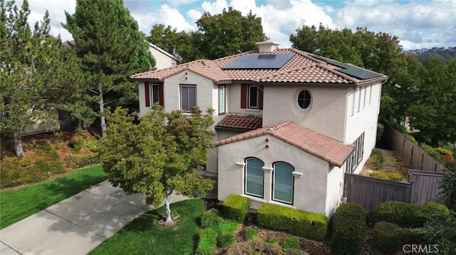 mediterranean / spanish-style home featuring solar panels