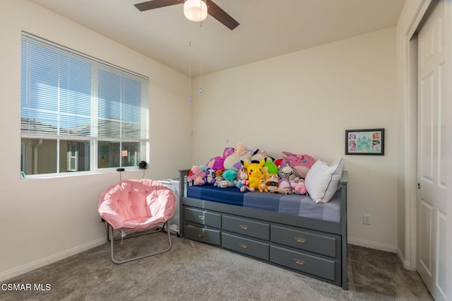 carpeted bedroom with ceiling fan and a closet