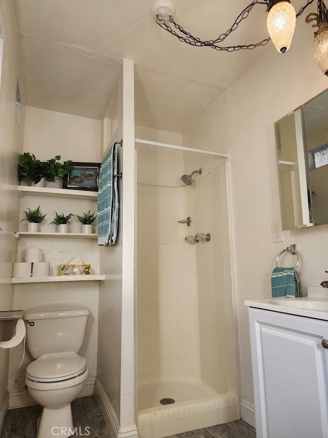 full bath with toilet, a stall shower, and vanity