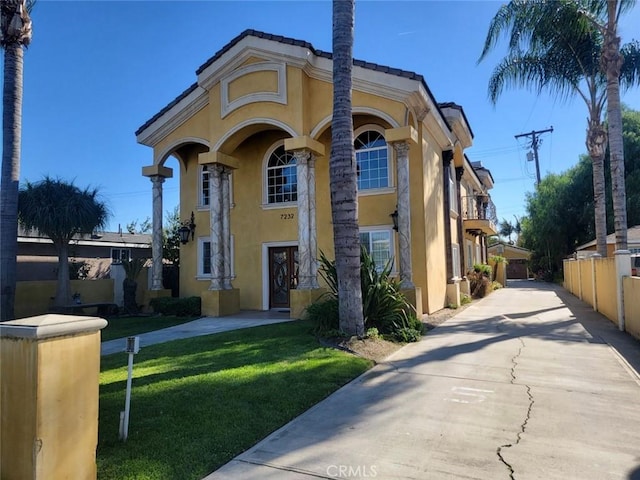 mediterranean / spanish-style home with a front yard