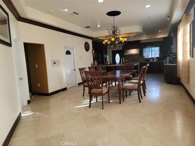 dining area featuring a tray ceiling, light tile patterned floors, and a notable chandelier