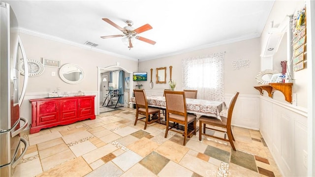 dining room featuring ceiling fan and ornamental molding