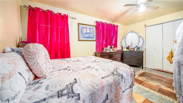 bedroom with ceiling fan and a closet