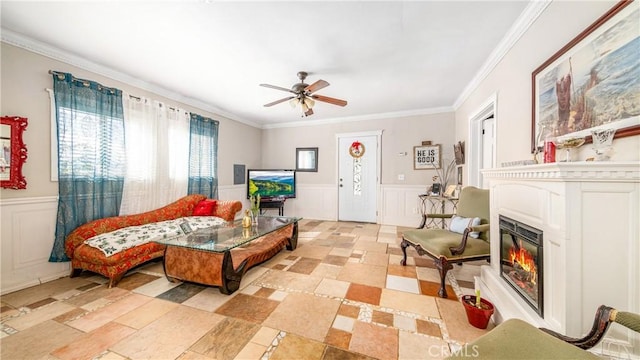 living room featuring ceiling fan and ornamental molding