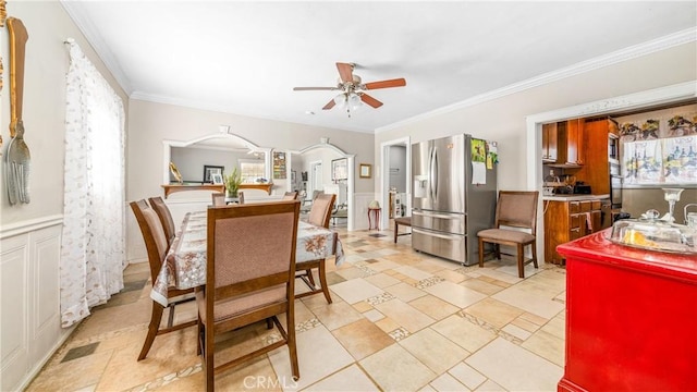 dining area featuring ceiling fan and crown molding