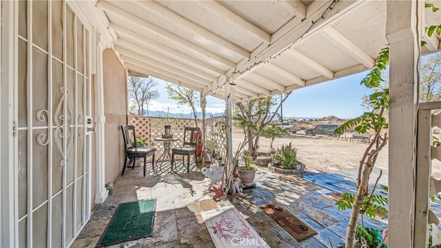 view of patio / terrace featuring a mountain view