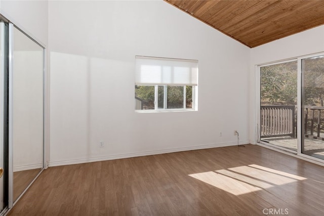 empty room featuring wooden ceiling, vaulted ceiling, and hardwood / wood-style flooring