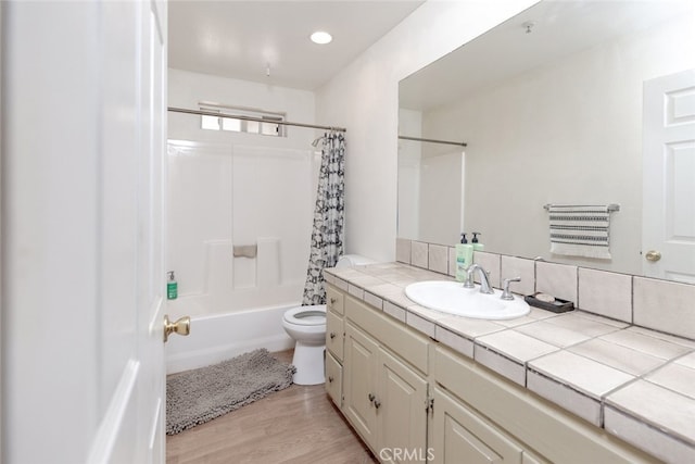 full bathroom featuring vanity, toilet, wood-type flooring, and shower / tub combo with curtain