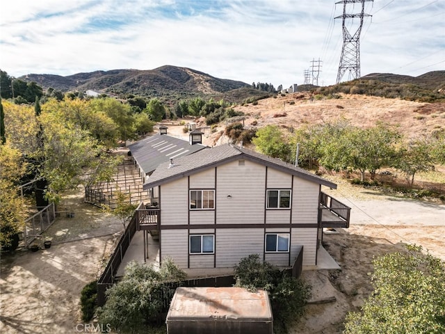 rear view of property featuring a mountain view