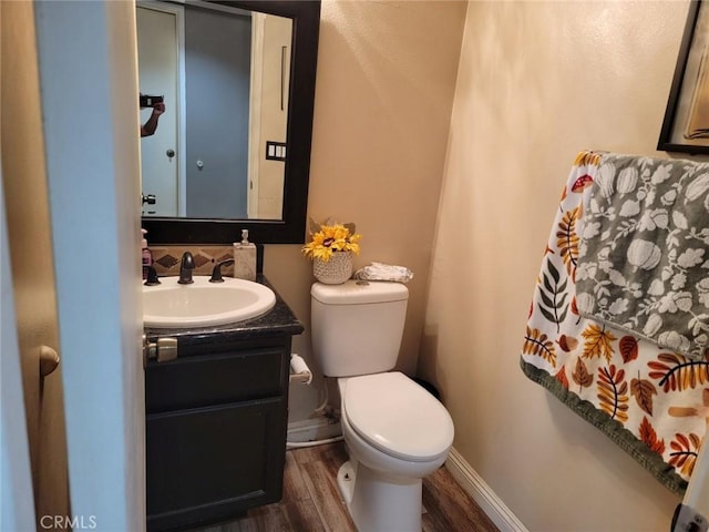 bathroom featuring hardwood / wood-style flooring, vanity, and toilet