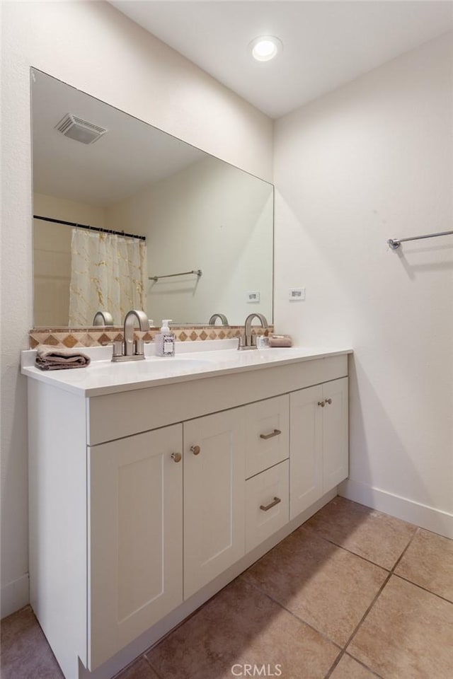 bathroom featuring tile patterned flooring and vanity