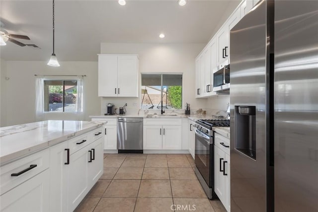 kitchen with white cabinets, pendant lighting, and appliances with stainless steel finishes