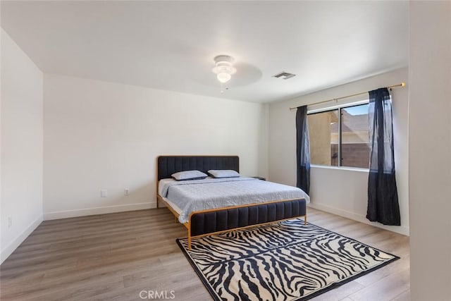 bedroom featuring light hardwood / wood-style floors and ceiling fan