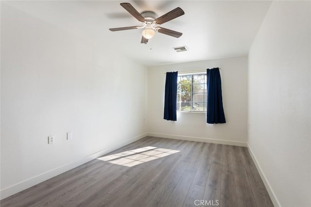 unfurnished room with hardwood / wood-style flooring and ceiling fan