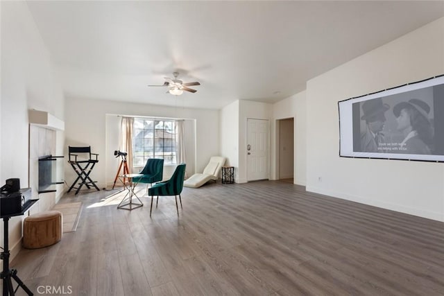 sitting room featuring hardwood / wood-style floors and ceiling fan