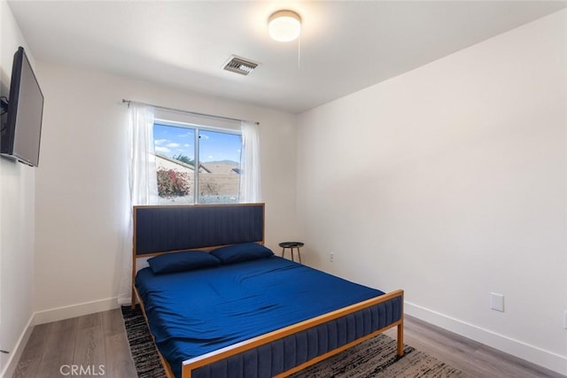 bedroom with hardwood / wood-style flooring