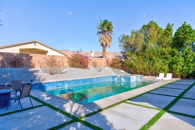 view of swimming pool with an in ground hot tub and a patio