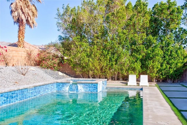 view of pool featuring an in ground hot tub and a mountain view