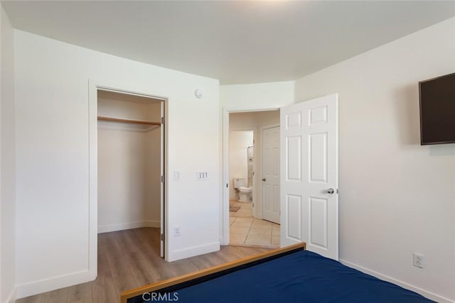 unfurnished bedroom featuring wood-type flooring and a closet