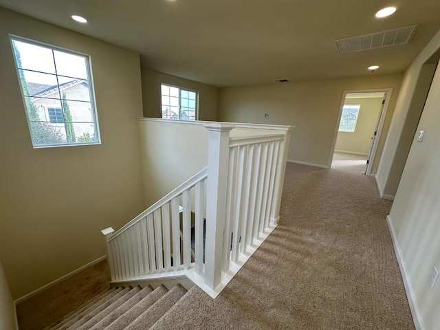 hallway with light colored carpet