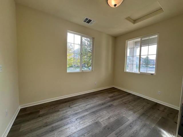 spare room with dark wood-type flooring