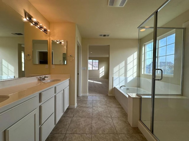 bathroom featuring tile patterned floors, vanity, and separate shower and tub