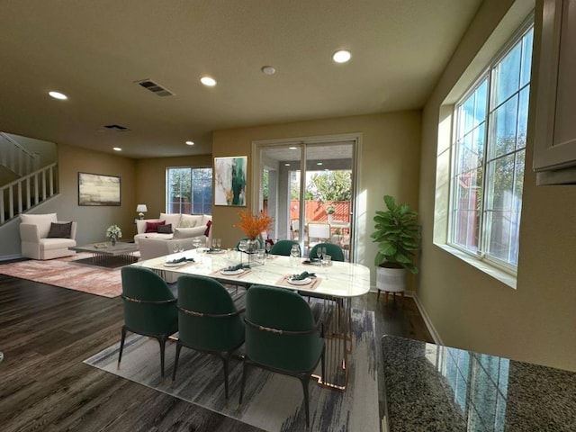 dining area featuring dark wood-type flooring