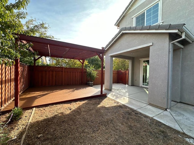 view of patio / terrace featuring a wooden deck and a pergola