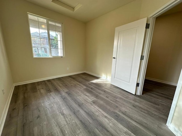 empty room featuring dark hardwood / wood-style flooring