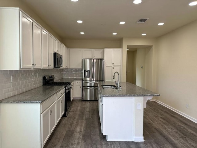 kitchen with white cabinets, sink, stainless steel fridge, and range with gas stovetop