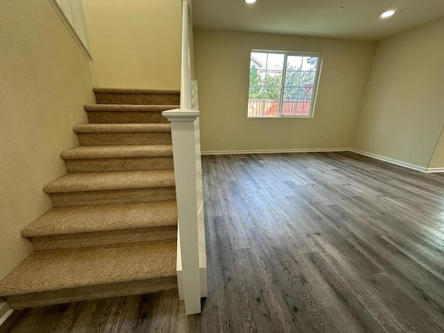 staircase featuring hardwood / wood-style flooring