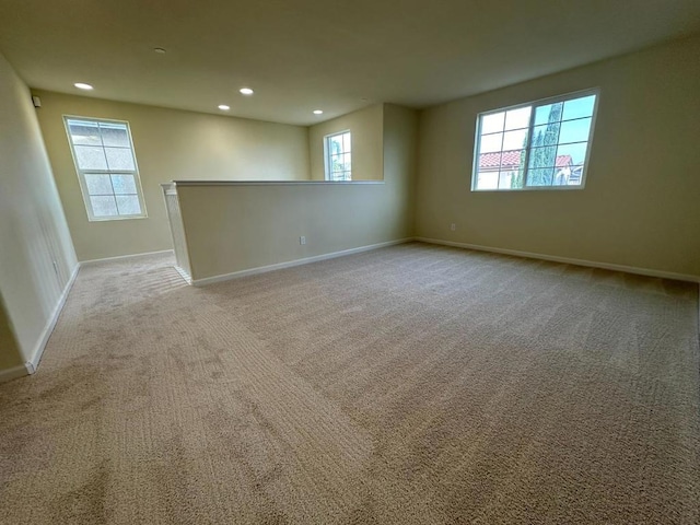 carpeted spare room with a wealth of natural light