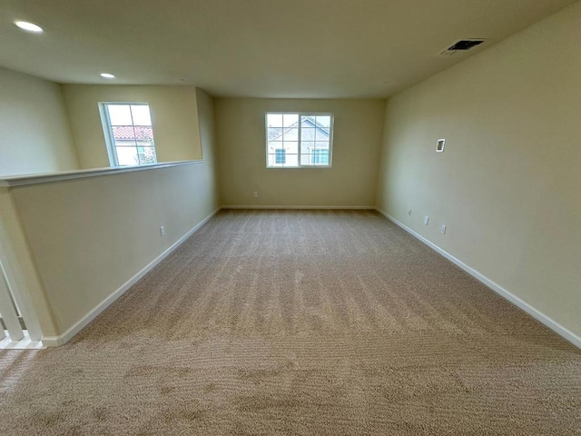 carpeted empty room with a healthy amount of sunlight