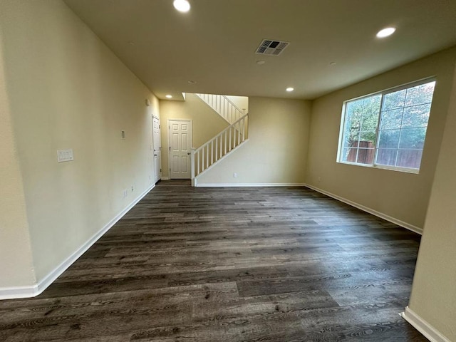 unfurnished living room with dark hardwood / wood-style flooring