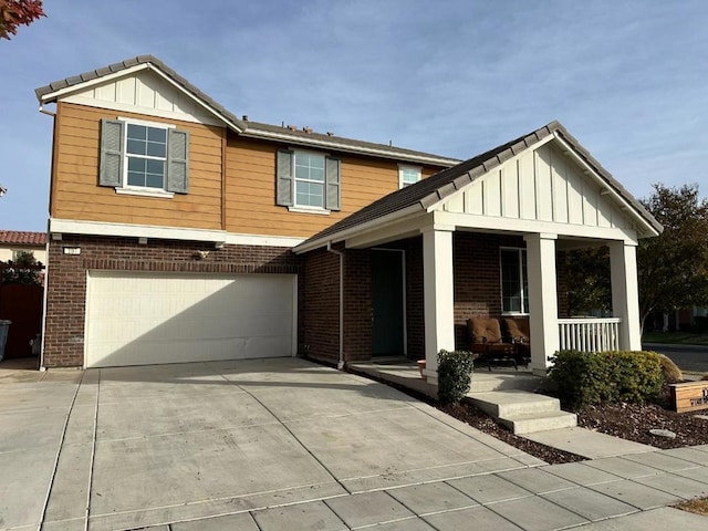 view of front of property with covered porch and a garage