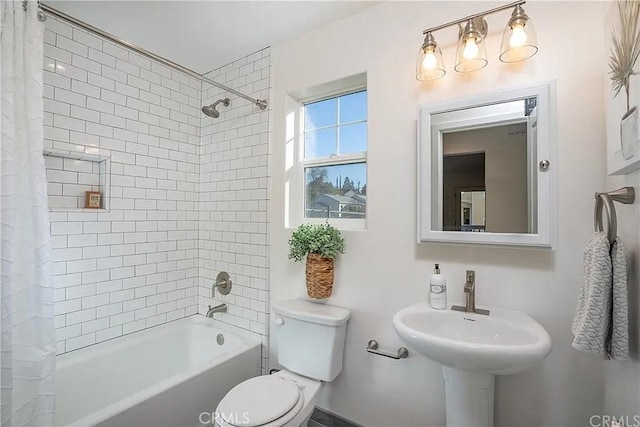 bathroom featuring shower / bath combo and toilet