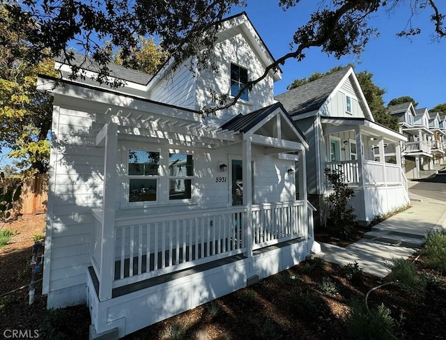 view of front of house featuring a porch and a pergola