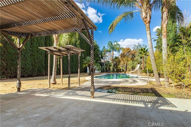 outdoor pool with a water slide, a patio, and a pergola