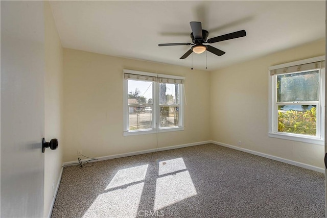 unfurnished room with a ceiling fan, carpet flooring, and baseboards