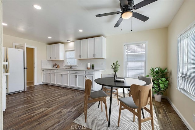 dining space featuring dark wood-style floors, baseboards, a wealth of natural light, and recessed lighting