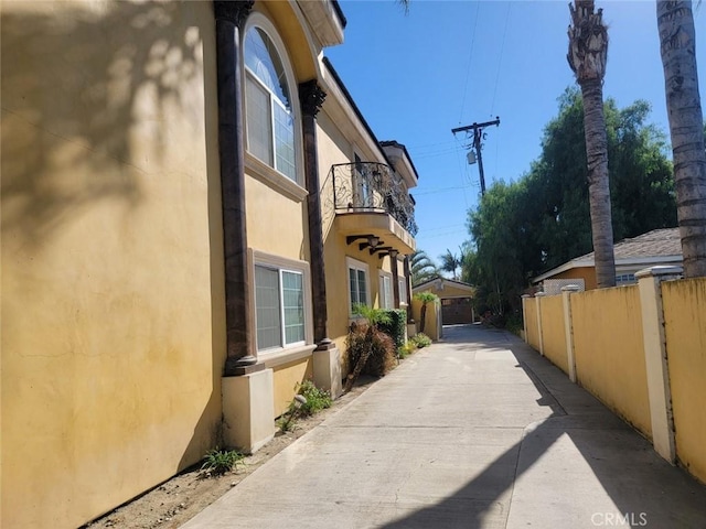 view of side of home with a balcony