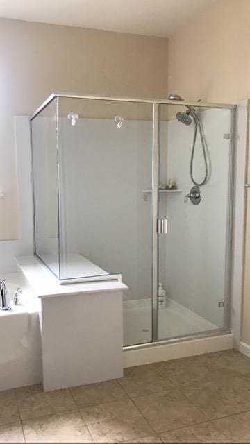 bathroom featuring separate shower and tub